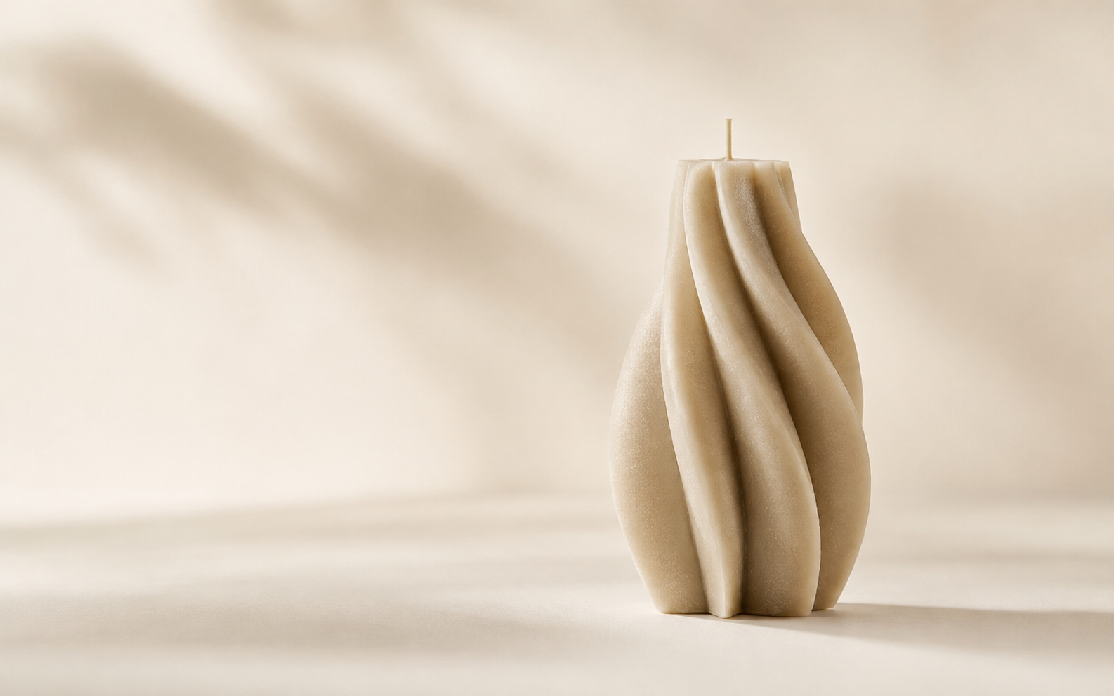 Single sculptural candle photographed as a premium design object