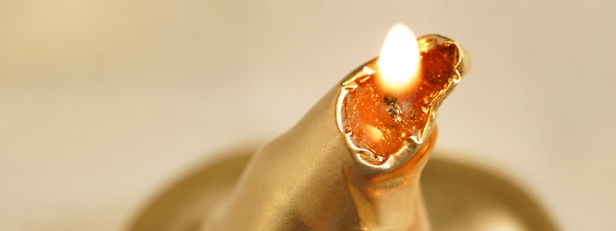 Sculptural candle form -- freestanding wax structure on a neutral studio surface, conveying geometry and burn logic