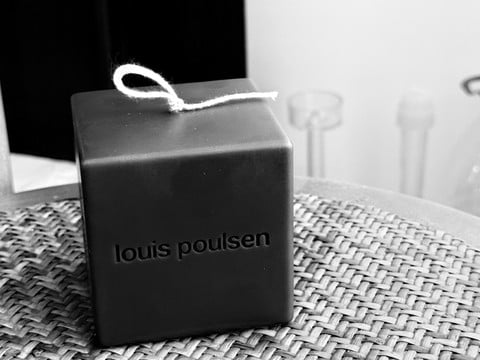Object-shaped candle form derived from brand identity or product reference on a development surface