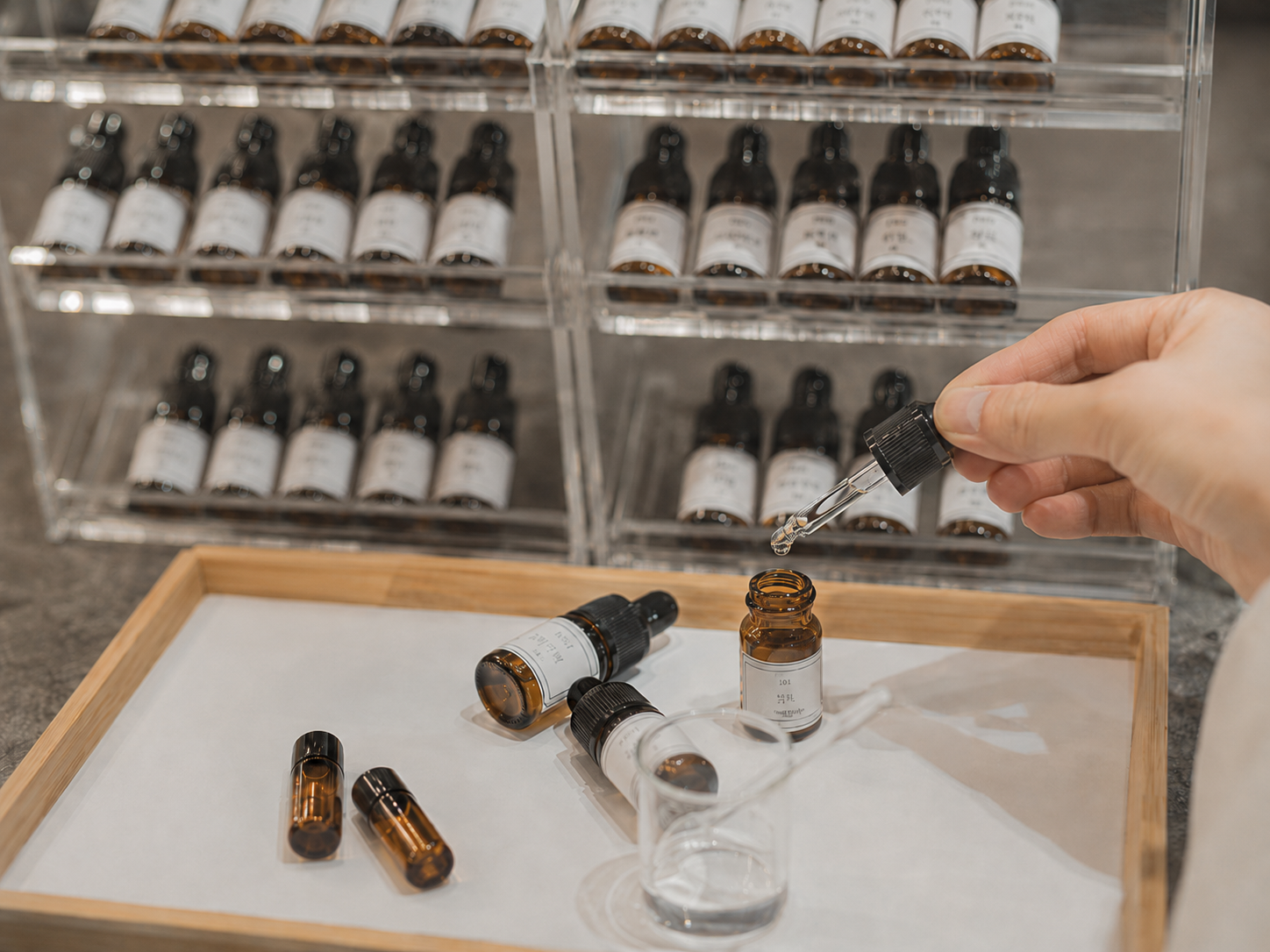 Close-up of essential oil bottles, droppers, and fragrance testing materials used for custom candle scent development at ZLCandle