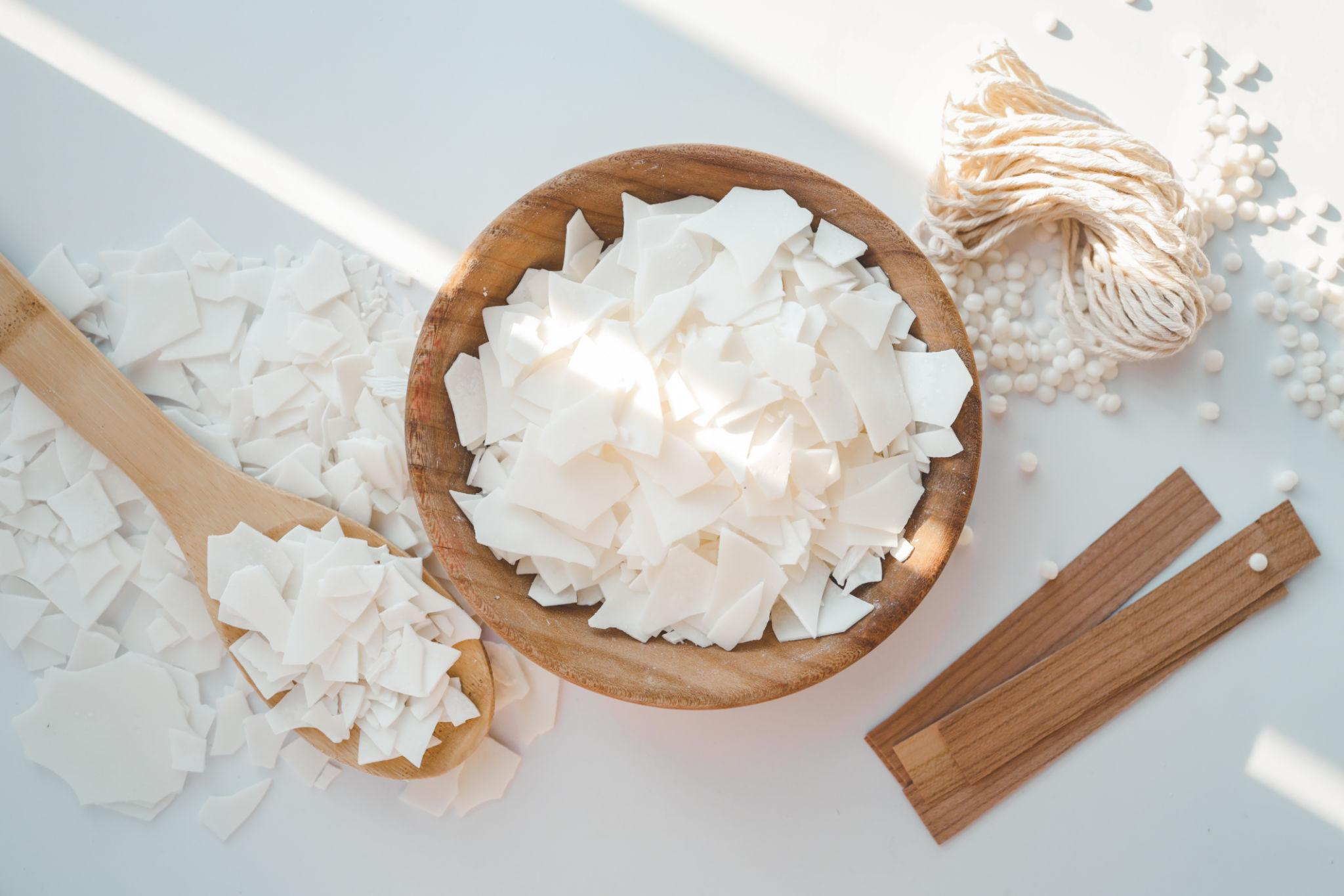 Product photo of a candle showing its wax surface and wick