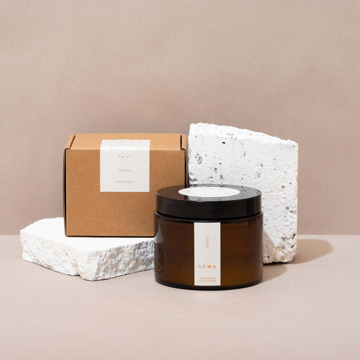 Product photo of a branded candle with custom gift packaging